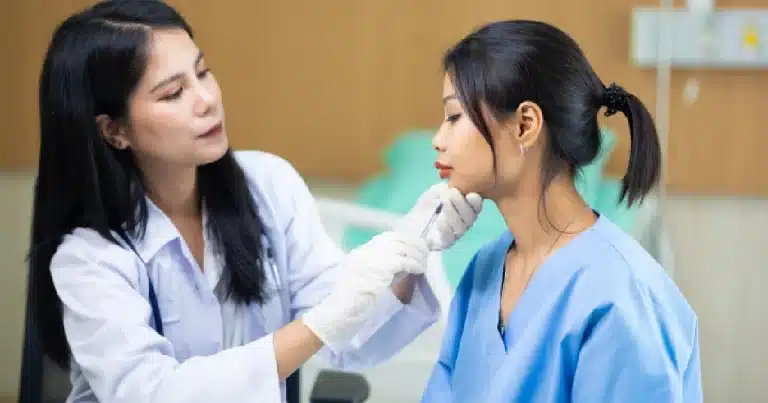 A doctor administering an injectable treatment to a seated patient